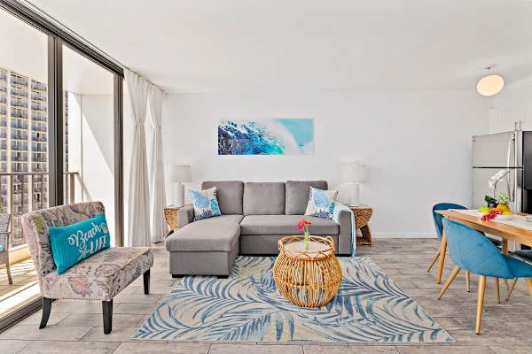 The living room has a L-shaped sofa, one person can sleep on it