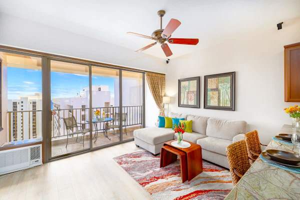 Living room with window AC and ceiling fan for optimal cool temperatures 