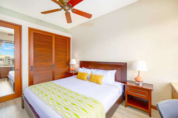 Bedroom with king-size bed, ceiling fan, closet, and ensuite bathroom