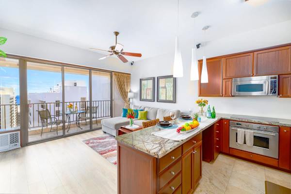The kitchen has a countertop with 2 bar stools!