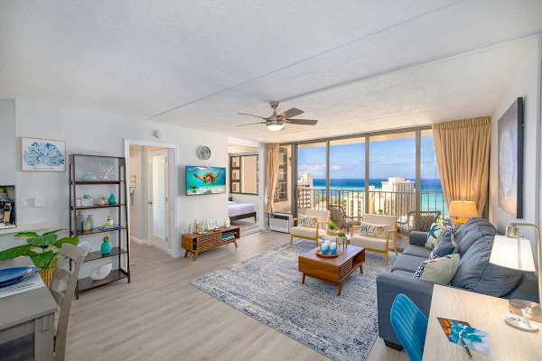 Living room with pull-out sleeper sofa, 2 chairs, smart TV, ceiling fan, and great ocean views.