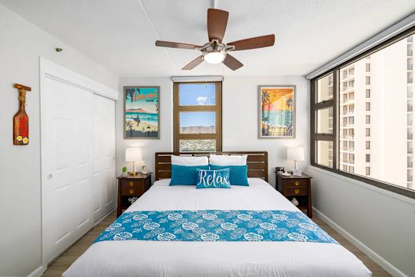 Bedroom with king size bed, ceiling fan, and Ocean views, and a glimpse of mountain view!