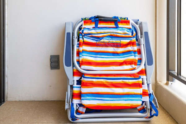 Two beach chairs and a beach umbrella are provided
