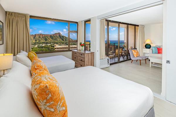 Bright bedroom with mountain views and a connected living area featuring ocean views.