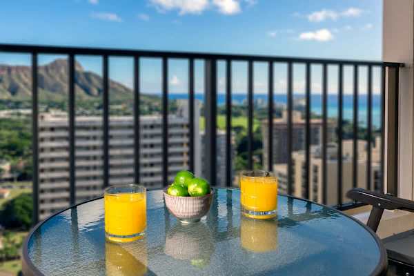 Enjoy a refreshing drink with a scenic city and mountain view from the balcony.