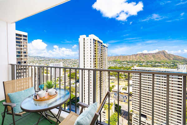 Relax on the balcony with city and mountain views in a high-rise setting.
