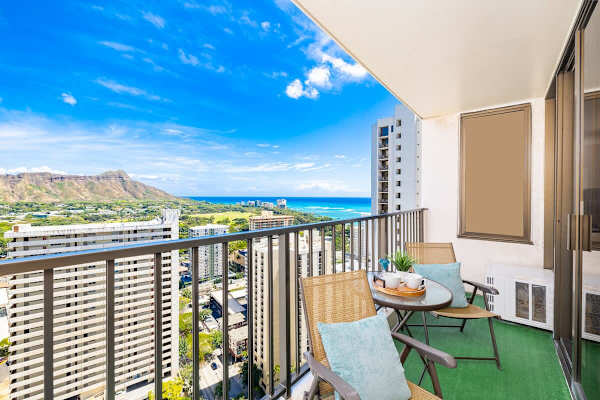 Relax on the balcony with ocean and mountain views in a modern city setting.