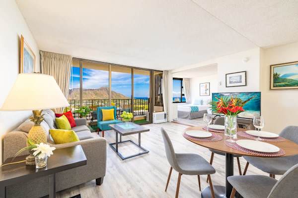 Bright living and dining area with mountain views and modern decor.