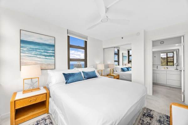 The bedroom has a king-sized bed and access to the bathroom