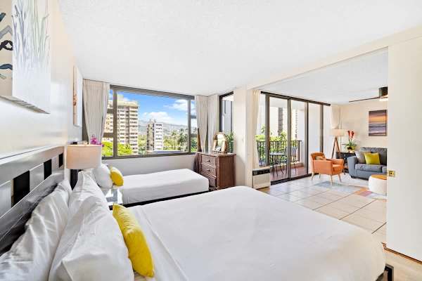 Bedroom with queen- and twin-size beds, a sliding door that separates from the living room.