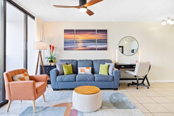 Living room with pull-out sleeper sofa, smart TV, a coffee table, and a comfortable chair.