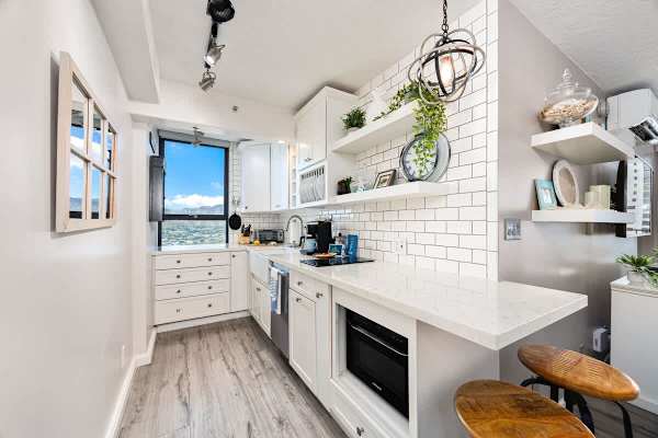 modern kitchen with white cabinetry, subway tile backsplash, and a view through the window