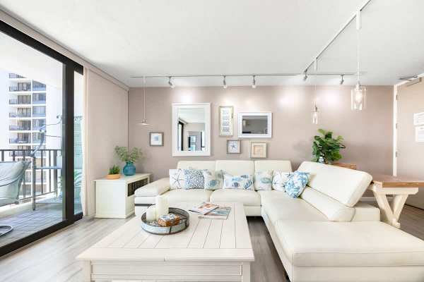 Bright living room with a white sectional sofa and coastal-themed decor