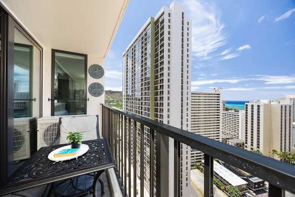 Relax on the balcony with city and ocean views in this modern high-rise apartment.