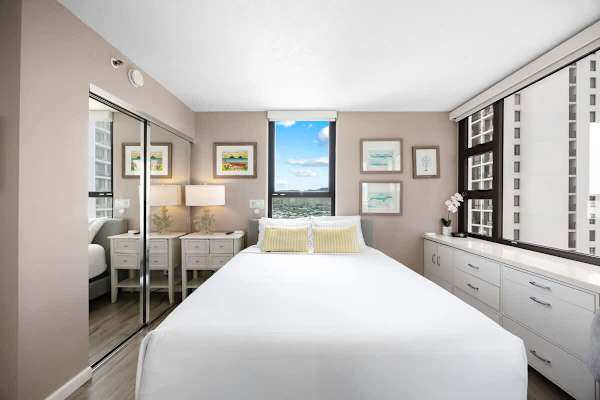 Bright bedroom with city views and modern storage solutions.