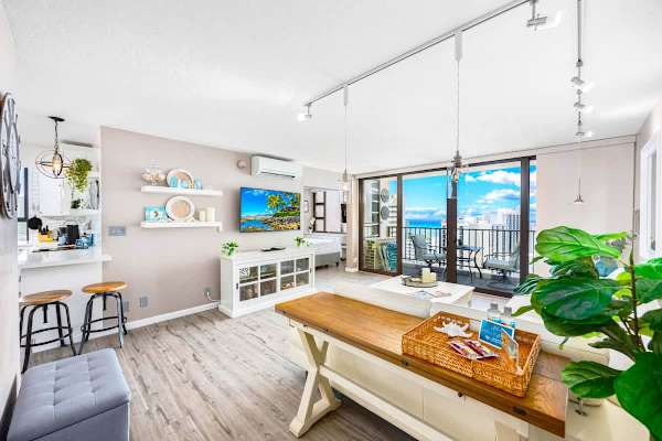 Bright living room with ocean view balcony and modern coastal decor.