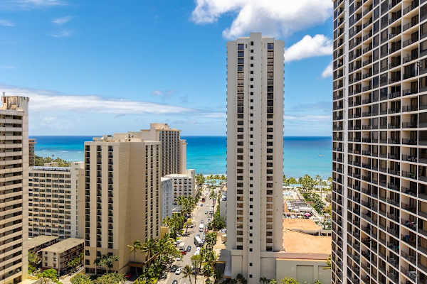Cityscape view with high-rise buildings and ocean in the background