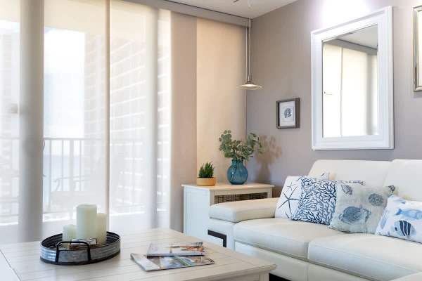 Relax in this bright living room with coastal-themed decor and soft natural light.