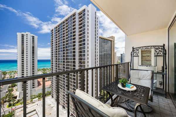 Relax on the balcony with ocean views and comfortable seating.