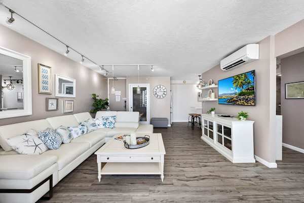 Spacious living room with a large sectional sofa and modern coastal decor.