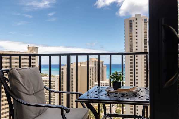 Relax on the balcony with ocean views and comfortable seating.
