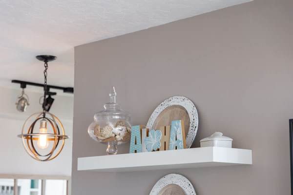 Modern shelf display with decorative aloha letters and ambient lighting.