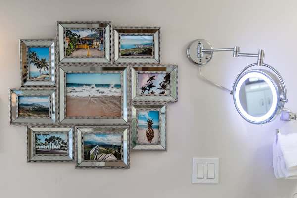 A collection of framed beach and tropical photos adds a relaxing touch to the room's decor.