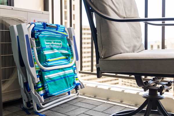 Relax on the balcony with cushioned seating and easy-to-store beach chairs.