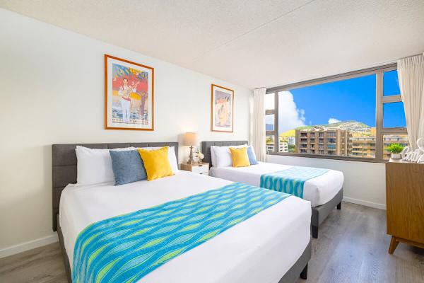 Bedroom with one queen-size and one full-size bed