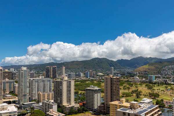 City skyline with mountain views under a clear blue sky