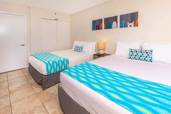 Bright guest room with two queen beds and colorful accents for a comfortable stay