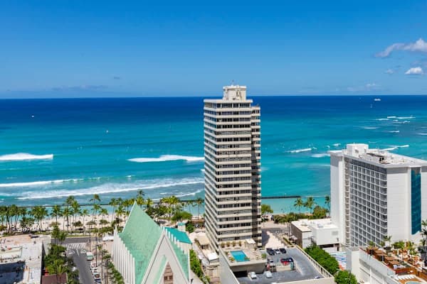Oceanfront high-rise with pool and beach access in a tropical setting