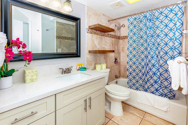 Bright bathroom with tiled shower and modern vanity