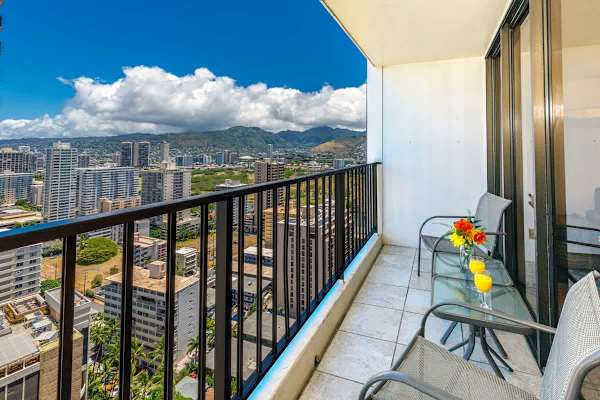 Relax on the balcony with city and mountain views in this modern high-rise apartment.