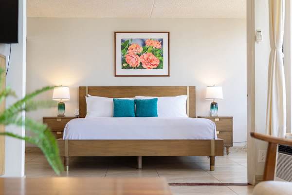 Wake up to a restful retreat w/ warm wood furniture & soft natural light.
