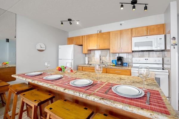 Dining area w/ warm lighting & seating for the whole group to gather.
