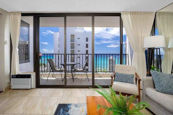 Balcony w/ comfortable seating — the perfect spot to unwind w/ the open sky ahead.
