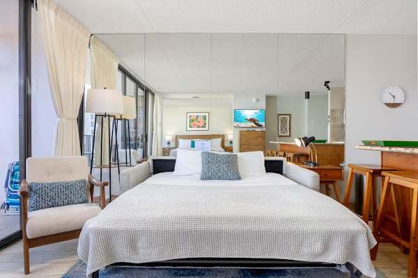 Bright bedroom w/ a cozy bed & soft linens — your peaceful retreat after a day of exploring.
