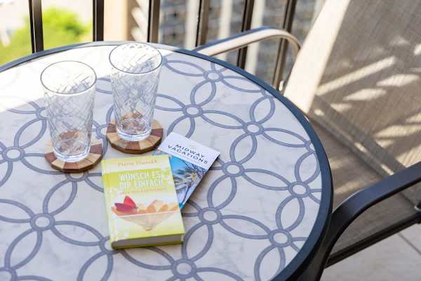 Enjoy the stunning views from the balcony, complete with outdoor furniture, including two chairs and a table—perfect for a relaxing escape.