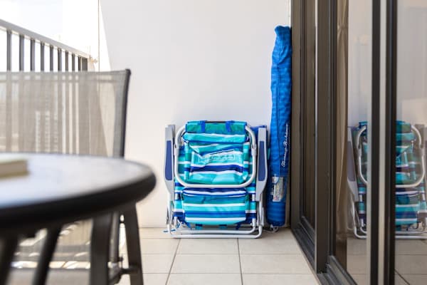 Find your beach chair conveniently stored on the balcony, ready to accompany you for a relaxing day by the shore.