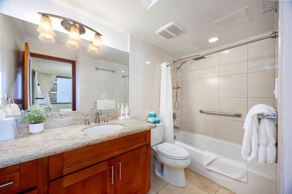Clean, modern bathroom w/ sink & tub for a refreshing start to your day.
