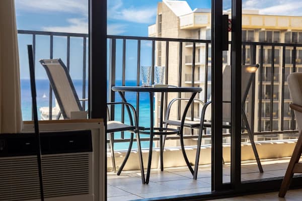 Enjoy the stunning views from the balcony, complete with outdoor furniture, including two chairs and a table—perfect for a relaxing escape.