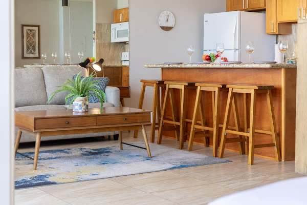 Bright kitchen w/ bar seating & warm wood tones — great for casual mornings.
