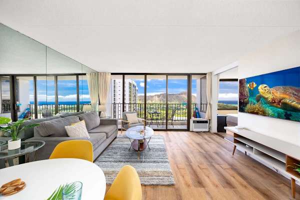 Modern living room with ocean and mountain views from the balcony