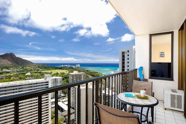 Relax on the balcony with ocean and mountain views in this high-rise apartment.