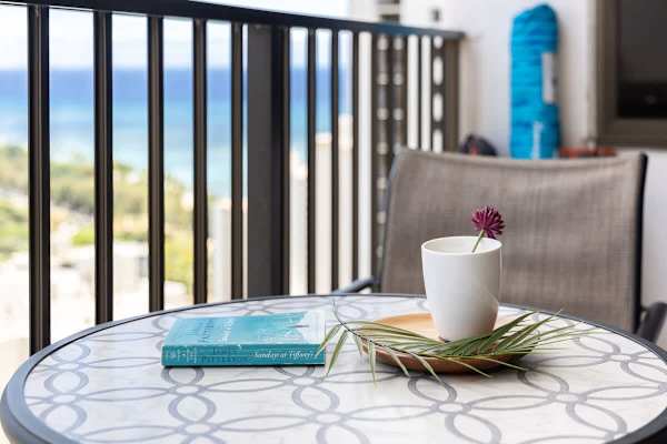 Relax on the balcony with ocean views and a cozy seating area.