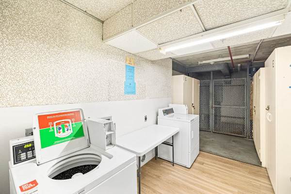 Shared paid laundry room with washers and dryers on every floor