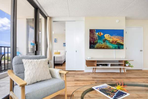 Modern living area with ocean views and a mounted flat-screen television.