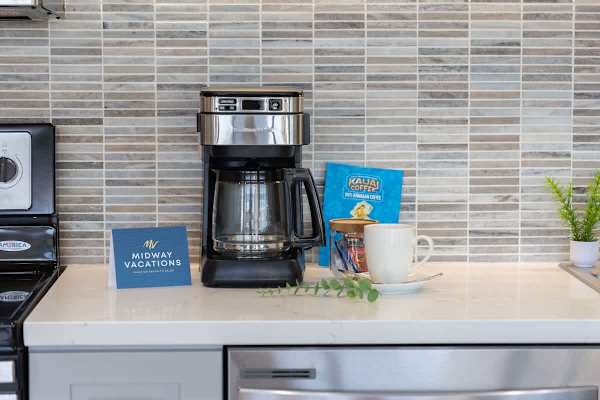 Modern kitchen counter with a coffee maker and Hawaiian coffee setup for a relaxing start.