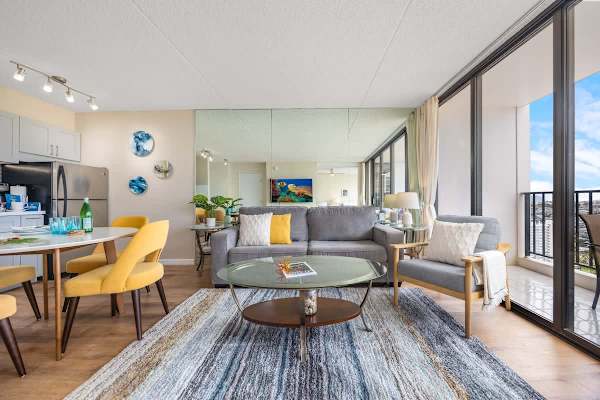 Modern living room with large windows offering city views and natural light